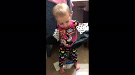 Toddler plays with gloves