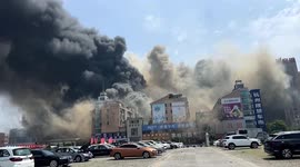Residents jump out of windows as fire tears through market in China