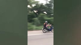 Rider uses feet to control motorbike in dangerous 'no hands' trick