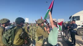 As Israeli soldiers continue to seize Palestinian flags, upset locals confront forces