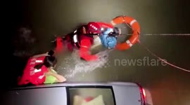 Firefighters save mother and daughter trapped in car that fell into river in China