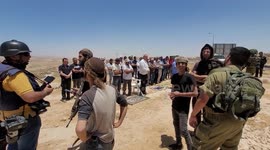 Palestinian activists scuffle with Israeli soldiers and Jewish settlers during a protest against a High Court decision to evict eight Palestinian communities in Masafer Yatta