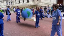 Doctors try to revive a dying Earth during a protest outside the Treasury