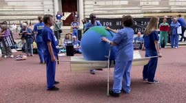 Extinction Rebellion activists attempt to revive Earth during protest outside Treasury
