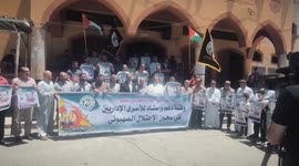 Gaza - Palestinians hold placards during a protest in solidarity with prisoners on hunger strike at Israeli jails