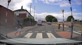 Lady too busy on mobile phone at pedestrian crossing