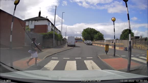 Lady too busy on mobile phone at pedestrian crossing