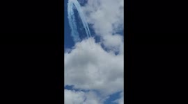 Red Arrows in Jubilee colours at airshow- Red white and blue, doing acrobatics
