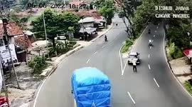 Truck topples over narrowly missing policeman before crashing into car