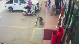 Parking fail! Motorcycle rider crashes into shop while picking up helmet