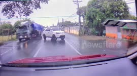 Heart-stopping moment tricycle grazes truck after overtaking on wet road