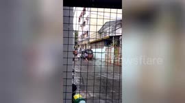 Kind residents use chairs as makeshift bridge to help neighbours cross flood