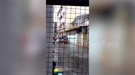 Kind residents use chairs as makeshift bridge to help neighbours cross flood