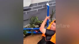 Police officers sucked into drainage culvert by floodwater in China