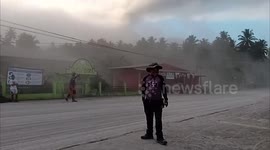 Hardworking locals sweep up ash left by Philippines volcano eruption