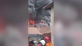 Fearless local stands on roofs to battle fire tearing through warehouse in Indonesia