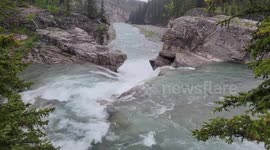 A before and after comparison of the drastic transformation of Elbow Falls during a historic rainfall