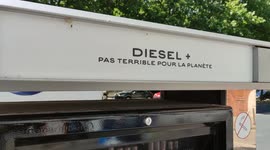 Humoristic and ecologic slang messages displayed at a gas station in Paris.   It reads in french:   - Diesel+, pas terrible pour la planète (Diesel, not terrible for the planet). In french not terrible means not so great  - Sans plomb 98, pas ouf non plus
