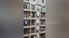 Crane lifts worker to save toddler dangling from fifth-floor balcony in China