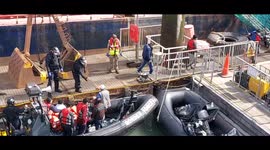 Migrants being unloaded from a Border Force RHIB at Dover port.