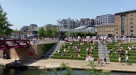 People sunbathe on a scorching day in London, UK