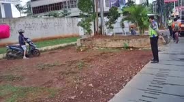 A motorcyclist falls while fleeing to avoid police raids in South Jakarta