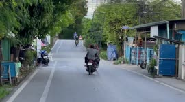 Motorcycle pillion passenger carries large metal fence