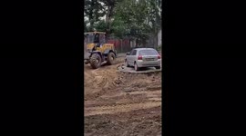 Baffled car owner watches his vehicle stuck in the middle of construction work