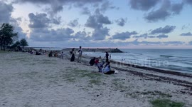 Locals enjoy sunset on beach in Narathiwat, southern Thailand