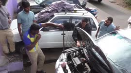 Large rat snake pulled out of car's engine by brave rescuer in souther India