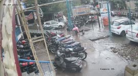 Police officer and wife fall into open drain on flooded road in northern India