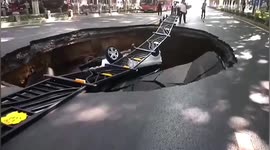 Huge sinkhole opens up in central China and swallows car and motorists