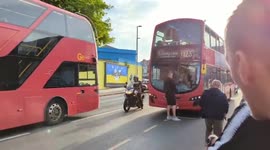 Man blocks bus as commuters queue amid UK rail strike