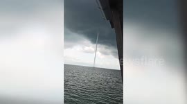 Powerful waterspout tornado rips through ocean before storm batters coastal hut (watch till the end)