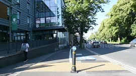 UK council build cycle lane littered with a speed camera, rubbish bins, trees and lampposts