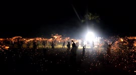 Indian festival sees hundreds wave firecrackers above their heads