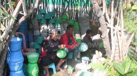 Indonesian volunteers recycle discarded diapers into pots and trash cans