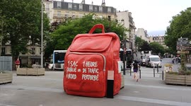 Giant bag at a rail station of Paris to warn commuter, travelers about abandoned luggage on metro (subway) and RER (Reseau Express Regional) trains. Giant backpack only from 16 to 23 june 2022. Filmed on june,22, 2022.