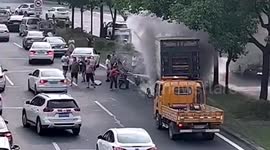Passing motorists rescue driver trapped in burning truck after crash in southern China