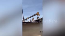 Crane collapses onto house injuring two people in Thailand