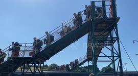 Thousands of Glastonbury Festival-goers arrive at Castle Cary train station near to the event