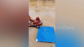 Firefighters rescue elderly man clinging onto debris in flood-stricken southern China