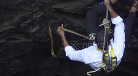Huge rat snake trapped in deep well in western India bites rescuer