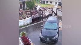 Metal gate collapses inches away from parked car after resident pushes it