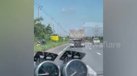 Truck wobbles along road with a broken axle in Thailand