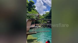 Flamboyant youngster busts a move on diving board before plunging into pool