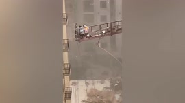 Workers on platform sent spiralling as powerful winds hit northern China