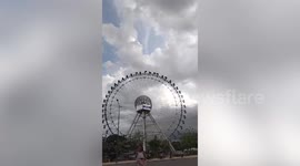 Gusts of wind flip baskets on Ferris wheel in Cambodia