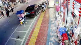 Scooter slams into parked car after Chinese woman presses accelerator by mistake
