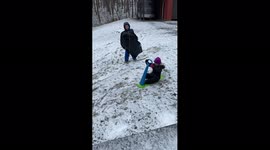 Boy Falls Off Sled